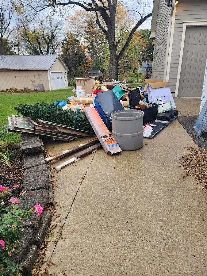 Dumpster being loaded with debris for Estate Cleanout Dumpster Rental in Hollymead